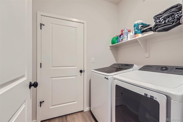 washroom featuring light hardwood / wood-style flooring and washing machine and dryer