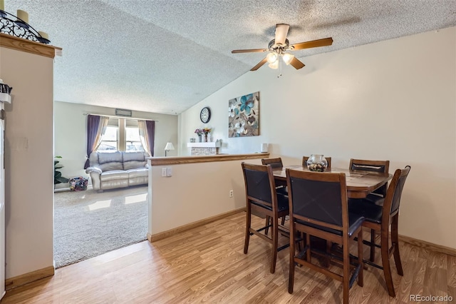 12425 Bellaire Dr, Thornton, CO 80241 - dining room featuring a textured ceiling, ceiling fan, light wood-style floors, lofted ceiling, and baseboards