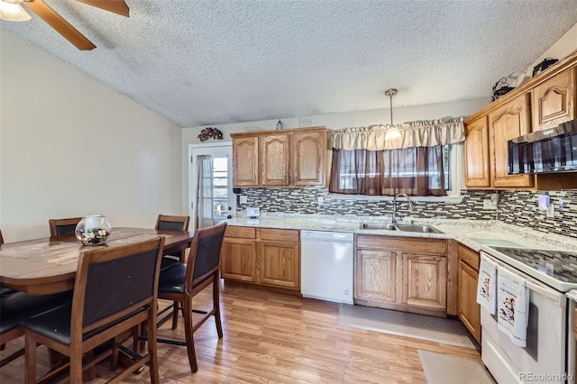 12425 Bellaire Dr, Thornton, CO 80241 - kitchen featuring white appliances, a sink, a textured ceiling, backsplash, and a ceiling fan
