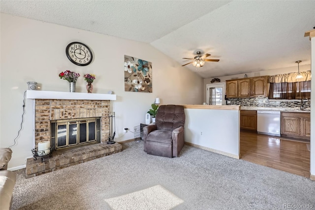 12425 Bellaire Dr, Thornton, CO 80241 - living room with light carpet, lofted ceiling, a ceiling fan, baseboards, and a fireplace