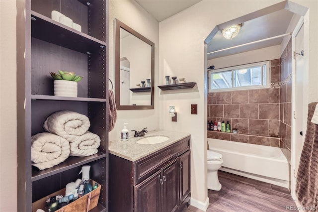 12425 Bellaire Dr, Thornton, CO 80241 - bathroom with toilet, wood finished floors, vanity, and washtub / shower combination