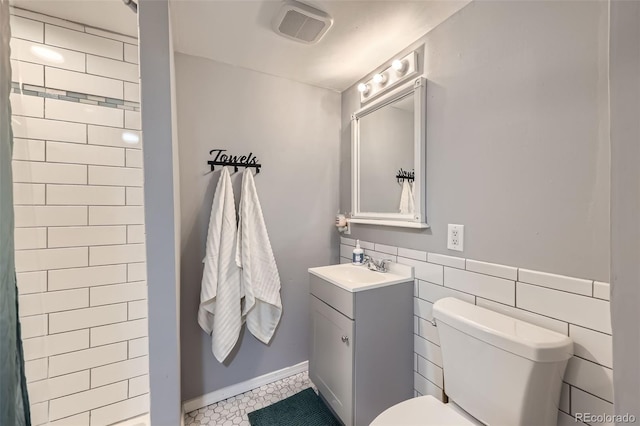 12425 Bellaire Dr, Thornton, CO 80241 - bathroom featuring toilet, vanity, a shower, and tile patterned flooring