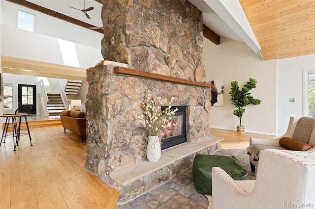 1952 Columbine Ct, Golden, CO 80401 - living room with a fireplace, stairway, a ceiling fan, wood finished floors, and plenty of natural light
