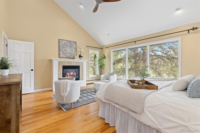 1952 Columbine Ct, Golden, CO 80401 - bedroom featuring baseboard heating, high vaulted ceiling, light wood finished floors, a tile fireplace, and recessed lighting