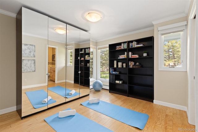 1952 Columbine Ct, Golden, CO 80401 - workout area featuring wood finished floors, ornamental molding, and a baseboard radiator