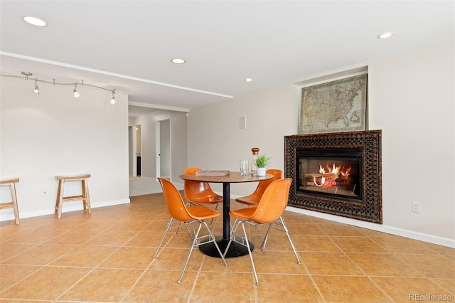 1952 Columbine Ct, Golden, CO 80401 - dining room featuring a glass covered fireplace, recessed lighting, and light tile patterned flooring