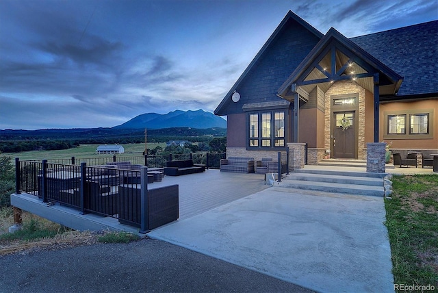 exterior space featuring an outdoor hangout area and a mountain view