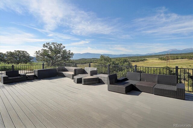 deck with a mountain view and an outdoor living space