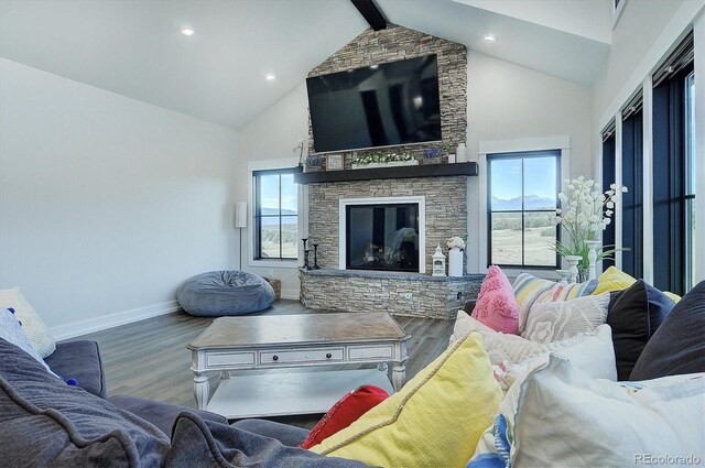 living room with beam ceiling, high vaulted ceiling, a fireplace, and hardwood / wood-style flooring