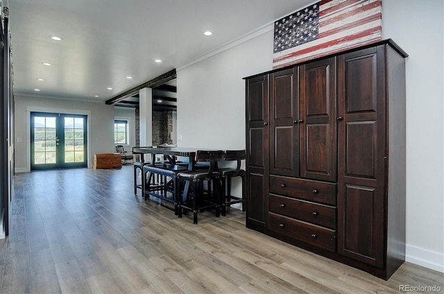 living room with french doors, light hardwood / wood-style flooring, and crown molding