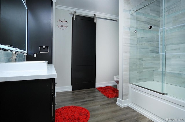 full bathroom featuring enclosed tub / shower combo, toilet, vanity, and hardwood / wood-style flooring