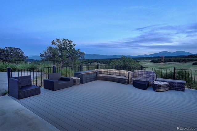 wooden terrace featuring outdoor lounge area and a mountain view