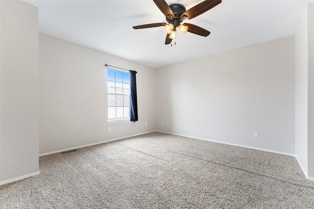 carpeted spare room with ceiling fan