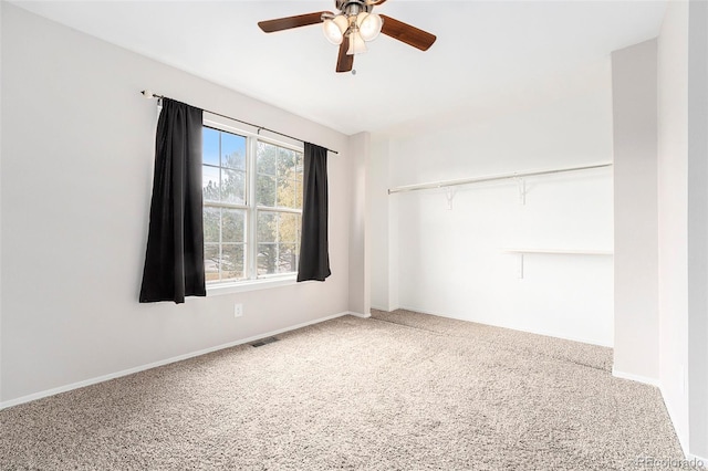 carpeted empty room with ceiling fan