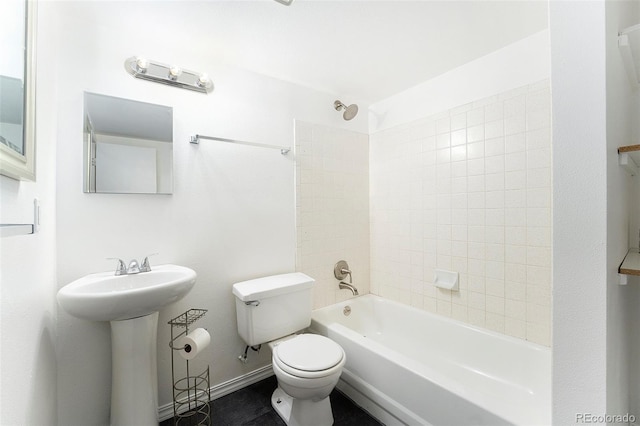 full bathroom with tiled shower / bath, toilet, and sink