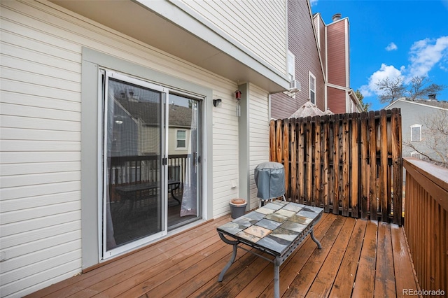 wooden deck with a grill