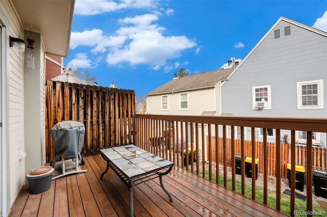 deck featuring area for grilling and cooling unit