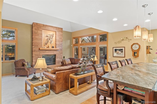 living room featuring a fireplace, baseboards, and recessed lighting