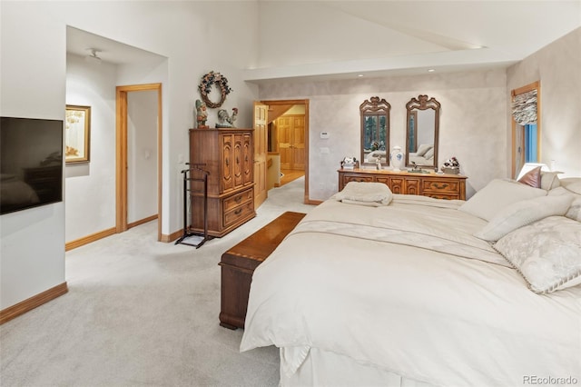 bedroom featuring light carpet, high vaulted ceiling, and baseboards