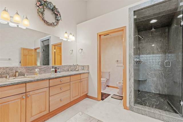 full bathroom featuring toilet, a sink, a shower stall, double vanity, and a bidet