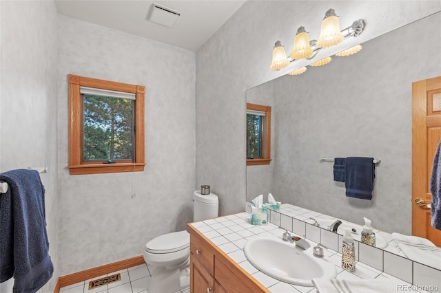 bathroom featuring toilet, tile patterned flooring, visible vents, and vanity