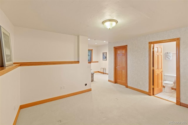 carpeted spare room featuring baseboards