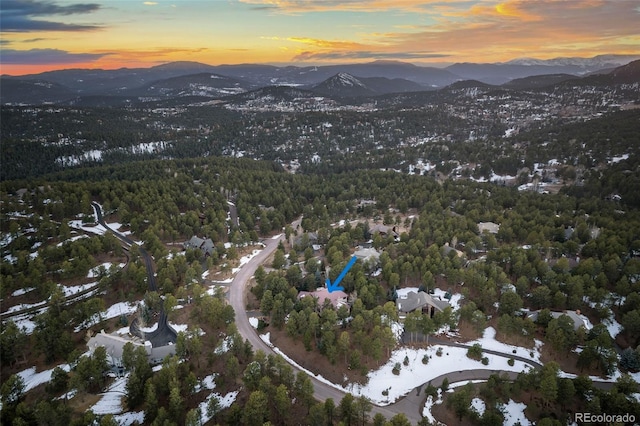 bird's eye view with a mountain view and a view of trees