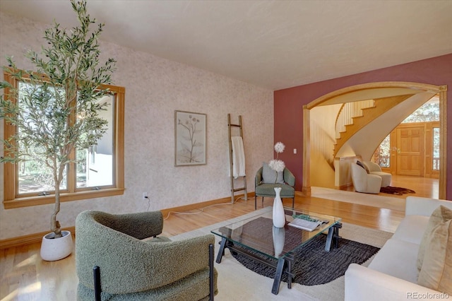 2828 Keystone Dr, Evergreen, CO 80439 - living room with wood finished floors, healthy amount of natural light, wallpapered walls, and baseboards