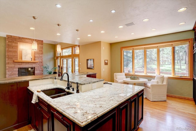 2828 Keystone Dr, Evergreen, CO 80439 - kitchen with a sink, open floor plan, a fireplace, recessed lighting, and plenty of natural light