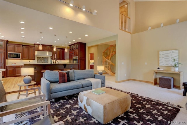 2828 Keystone Dr, Evergreen, CO 80439 - living area featuring stairway, light carpet, recessed lighting, and baseboards