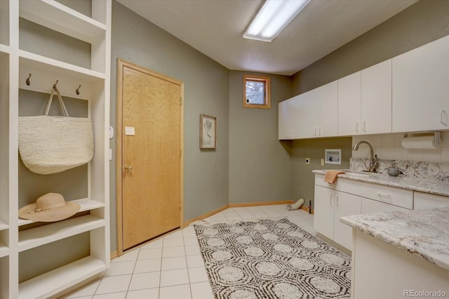 2828 Keystone Dr, Evergreen, CO 80439 - laundry area featuring hookup for a washing machine, cabinet space, light tile patterned floors, baseboards, and hookup for an electric dryer