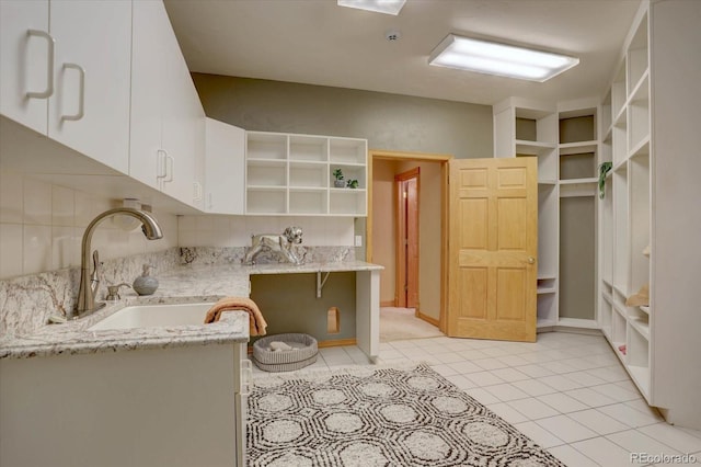 2828 Keystone Dr, Evergreen, CO 80439 - kitchen featuring open shelves, a sink, white cabinetry, light tile patterned flooring, and light stone counters