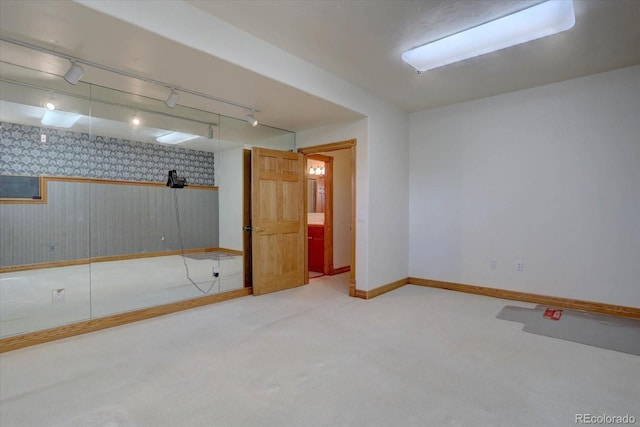 2828 Keystone Dr, Evergreen, CO 80439 - below grade area featuring wallpapered walls, baseboards, carpet, and rail lighting