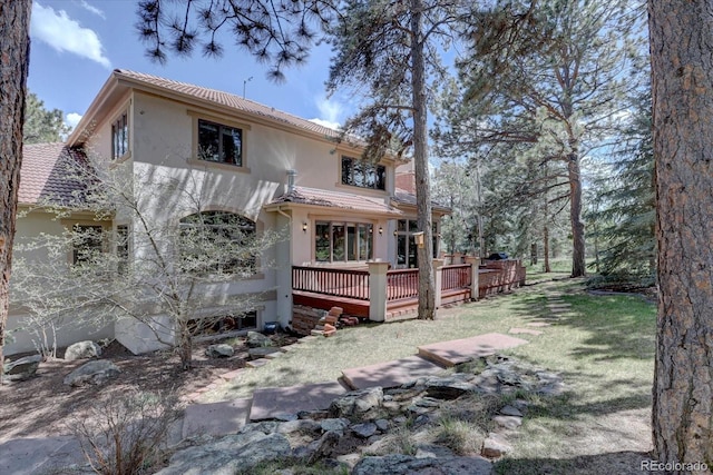2828 Keystone Dr, Evergreen, CO 80439 - rear view of property with stucco siding, a deck, and a tiled roof