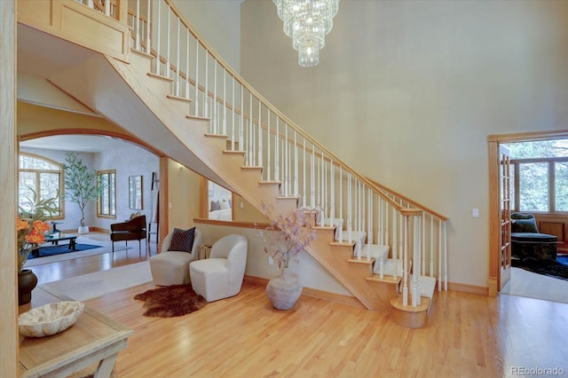 2828 Keystone Dr, Evergreen, CO 80439 - stairway featuring a towering ceiling, wood finished floors, arched walkways, and baseboards