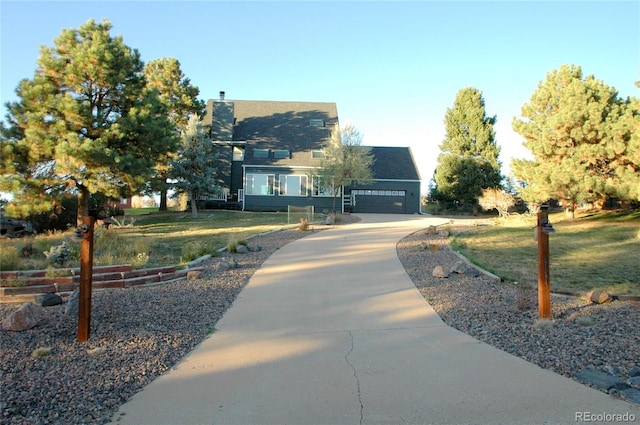 view of front of home with a front yard and a garage