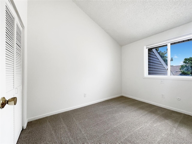 1925 28th Ave Unit 34, Greeley, CO 80634 - unfurnished bedroom with carpet floors, a textured ceiling, lofted ceiling, and a closet