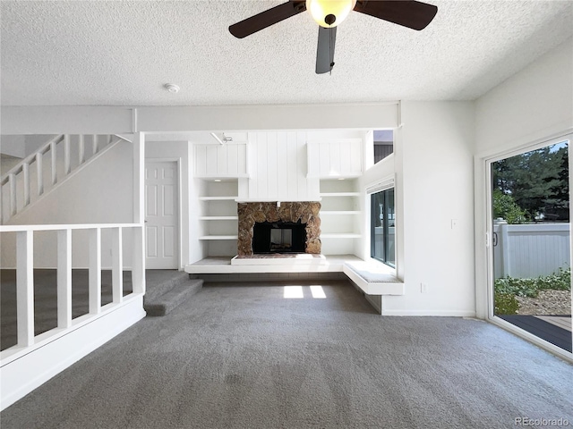 1925 28th Ave Unit 34, Greeley, CO 80634 - unfurnished living room with carpet flooring, a textured ceiling, a ceiling fan, and healthy amount of natural light