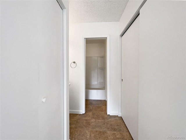 1925 28th Ave Unit 34, Greeley, CO 80634 - hallway with baseboards and a textured ceiling