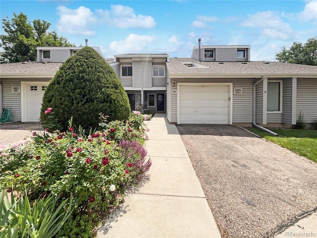 1925 28th Ave Unit 34, Greeley, CO 80634 - view of front of home featuring an attached garage, asphalt driveway, and a shingled roof