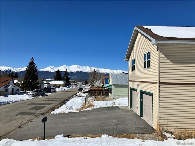 exterior space with an attached garage and a mountain view