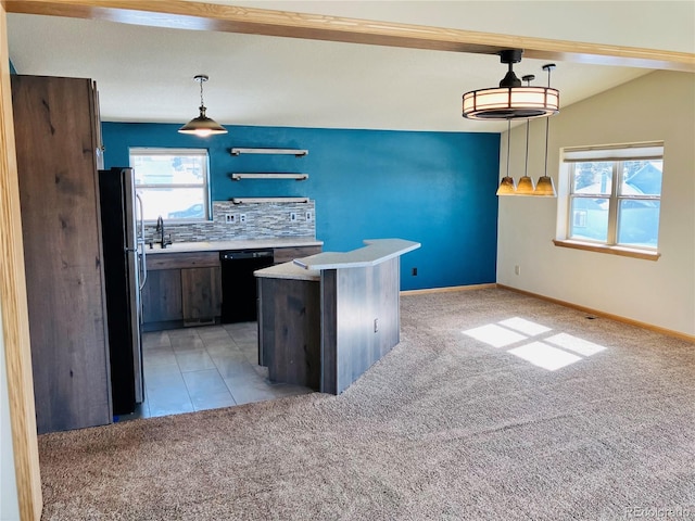 kitchen with light carpet, dishwasher, a healthy amount of sunlight, and freestanding refrigerator