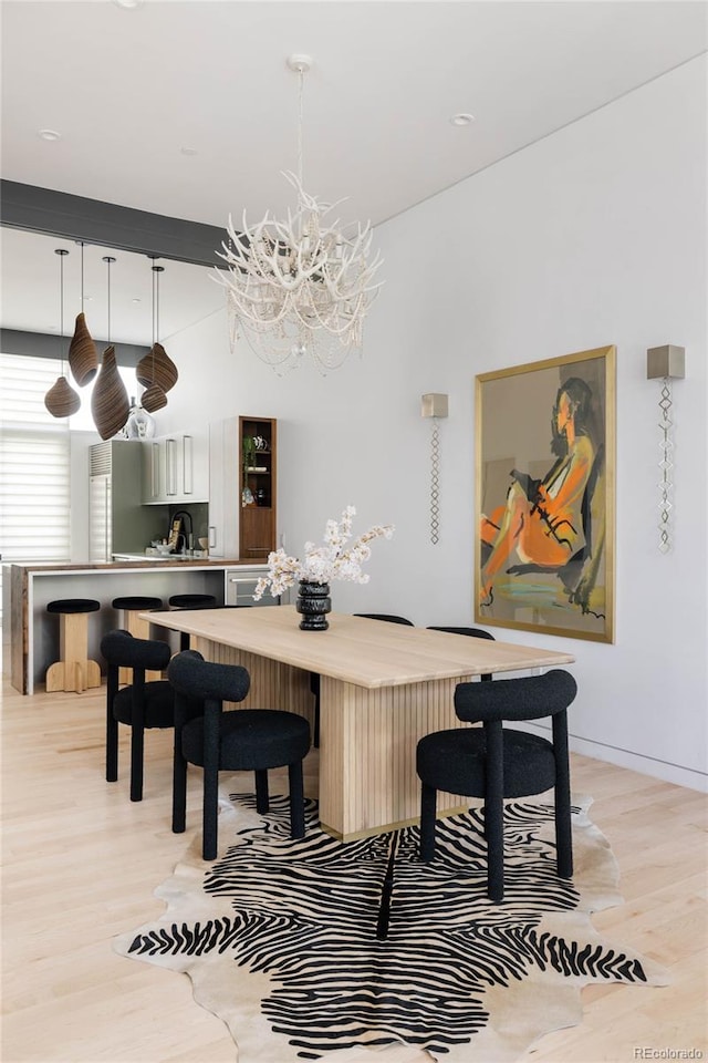 dining room featuring light hardwood / wood-style floors and a chandelier