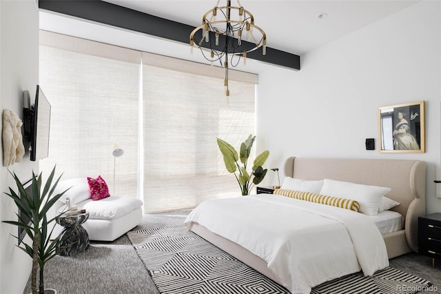 carpeted bedroom with a notable chandelier