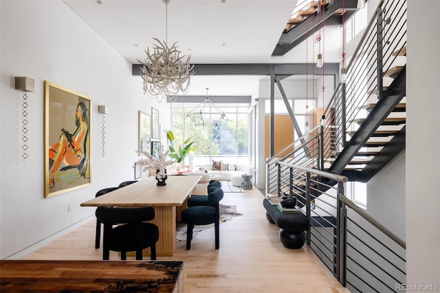 dining space with a notable chandelier and light wood-type flooring