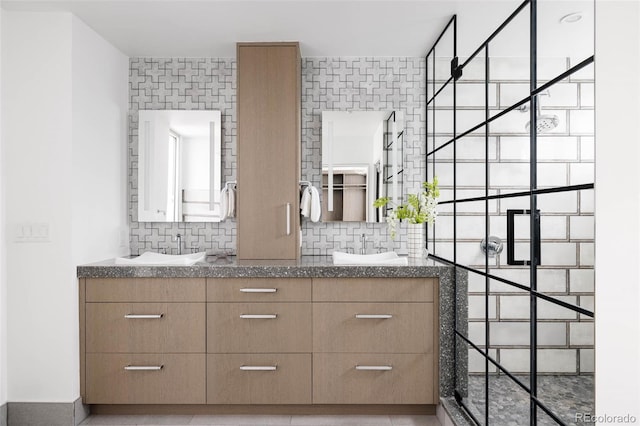 bathroom featuring vanity, decorative backsplash, and walk in shower