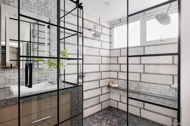 bathroom with tile walls, sink, and a bath