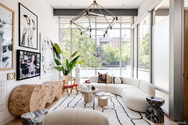 sunroom / solarium with a notable chandelier