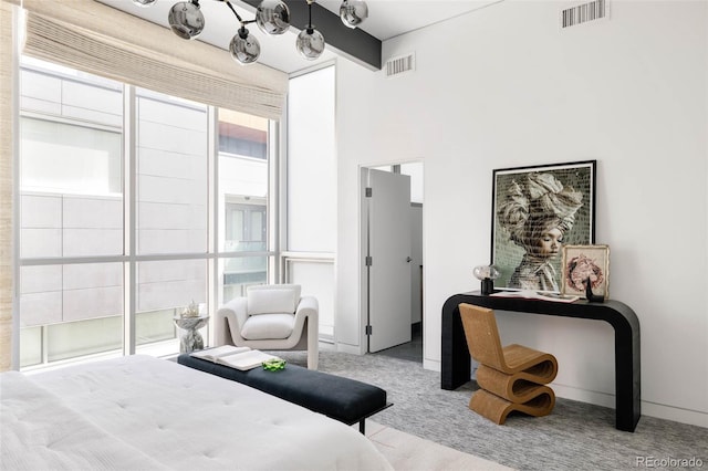 bedroom with visible vents, carpet flooring, baseboards, and beamed ceiling