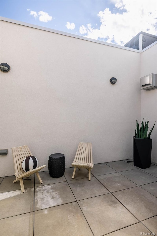 view of patio featuring an AC wall unit